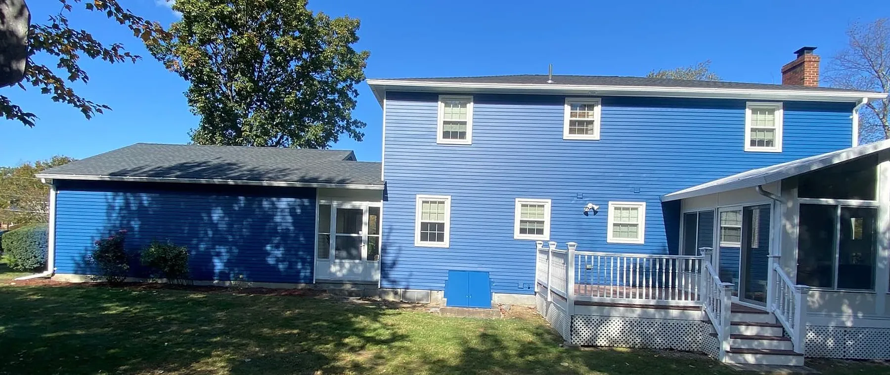 Blue two-story home in Peabody freshly painted with white trim